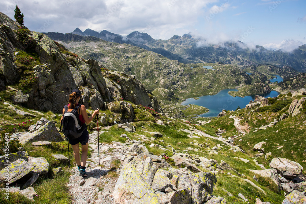 Young hiker girl summit to Ratera Peak in Aiguestortes and Sant Maurici National Park, Spain