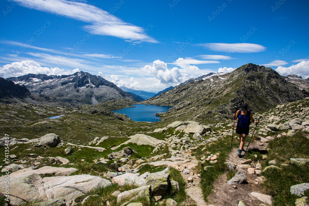 Young hiker girl summit to Montardo Peak in AIguestortes and Sant Maurici National Park, Spain