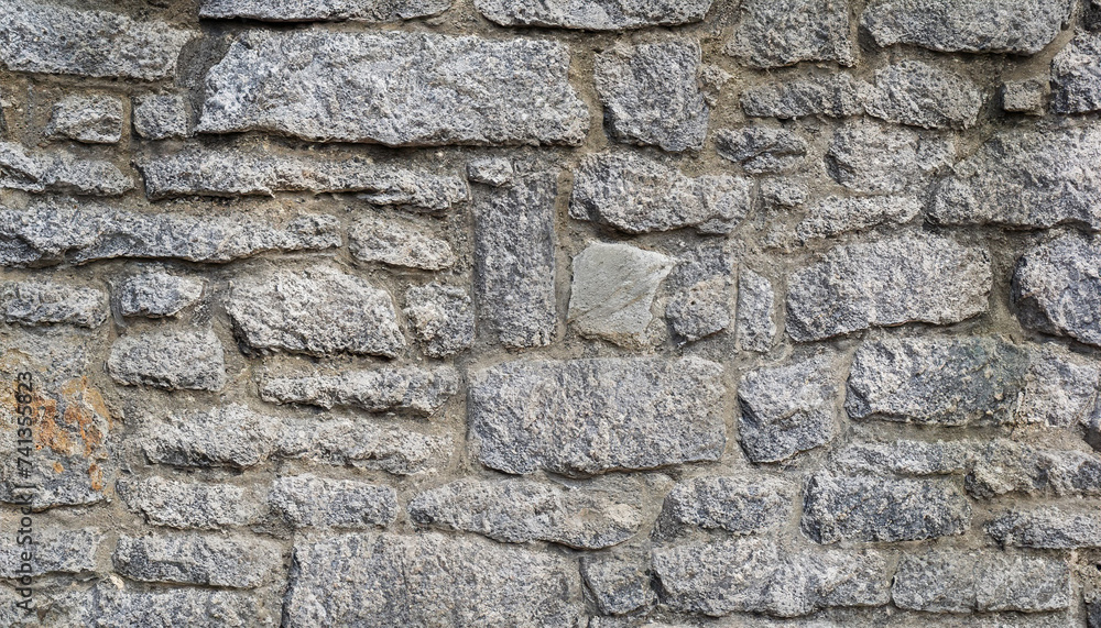 Masonry texture of natural gray stone; wall with a rough surface Masonry texture of natural gray stone; wall with a rough surface