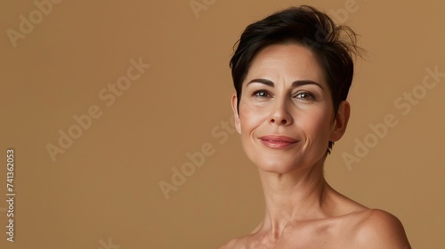 portrait of a beautiful woman 45 years old with healthy skin on a beige background, concept of natural beauty and healthy skin