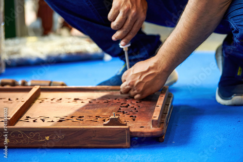 A worker is installing traditional Chinese wooden furniture photo