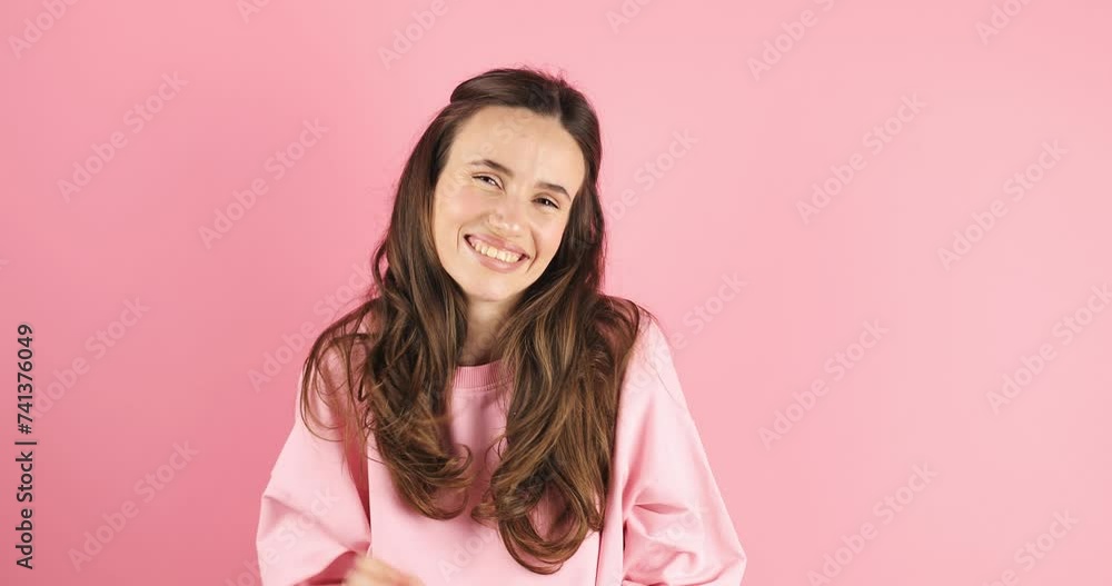 Confident happy blithesome young woman wear pink long sleeves top fix her hair, pointing hands on herself blinking showing on herself gesture isolated on pink background. Hey it's me. I am the best. Confident happy blithesome young woman wear pink long sleeves top fix her hair, pointing hands on herself blinking showing on herself gesture isolated on pink background. Hey it's me. I am the best.