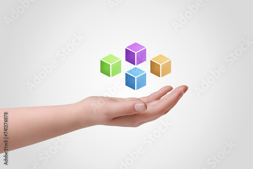 Hand holding levitating blockchain cubes with binary code  symbolizing digital empowerment and innovation. Ideal for technology and finance concepts