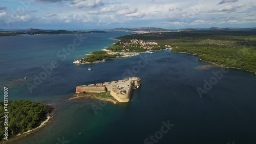 Aerial view of tranquil Otok Skoljic island with fort, Sibenik, Croatia. photo