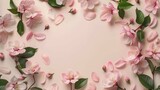 Spring flowers and leaves frame background with sakura petals, copy space in center, ideal for greeting card