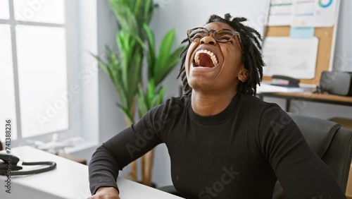 Furious young black woman with dreadlocks at office, screaming in frustration, working on laptop, enraged with mad anger photo