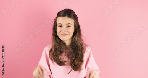 Brunette woman looking camera pointing fingers herself ask me no i do not need it. Girl point on her, waving her hands and say no isolated on pink background. photo