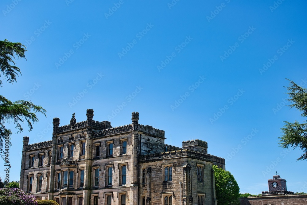 Elvaston, Derby, Derbyshire, England, UK. June 20, 2020 Front view of Elvaston Castle on a sunny day with surrounding green parkland and blue sky. This was during the Covid 19 Pandemic.