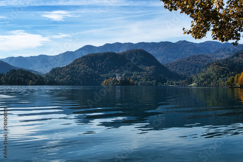 Lake Bled, Slovenia - October 18, 2021: A long distance view of Bled Island in Autumn, amid a green and blue natural landscape