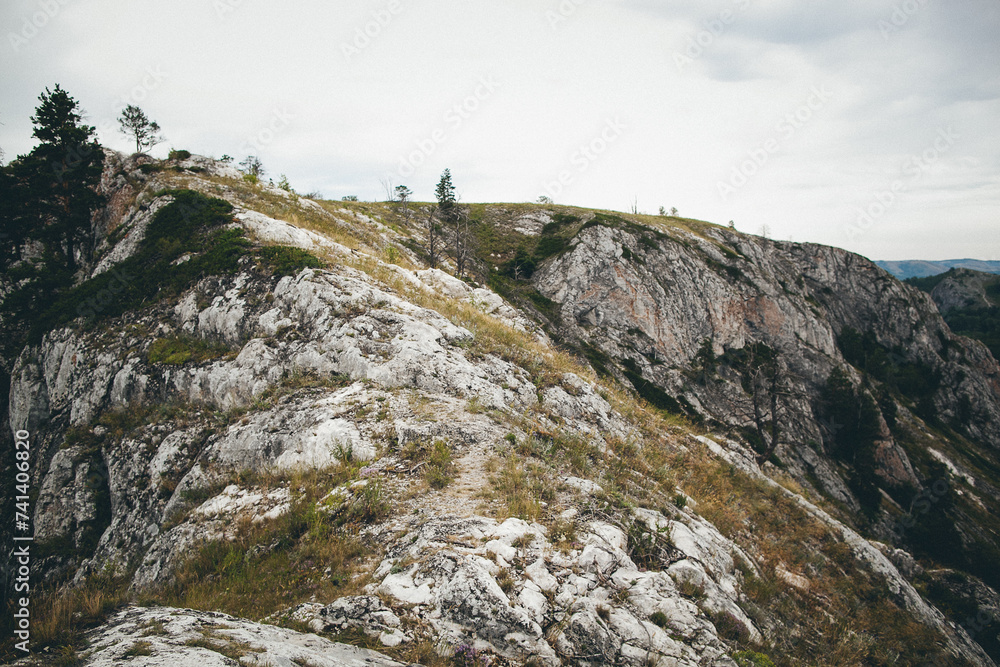 a group of people are standing on top of a rocky mountain