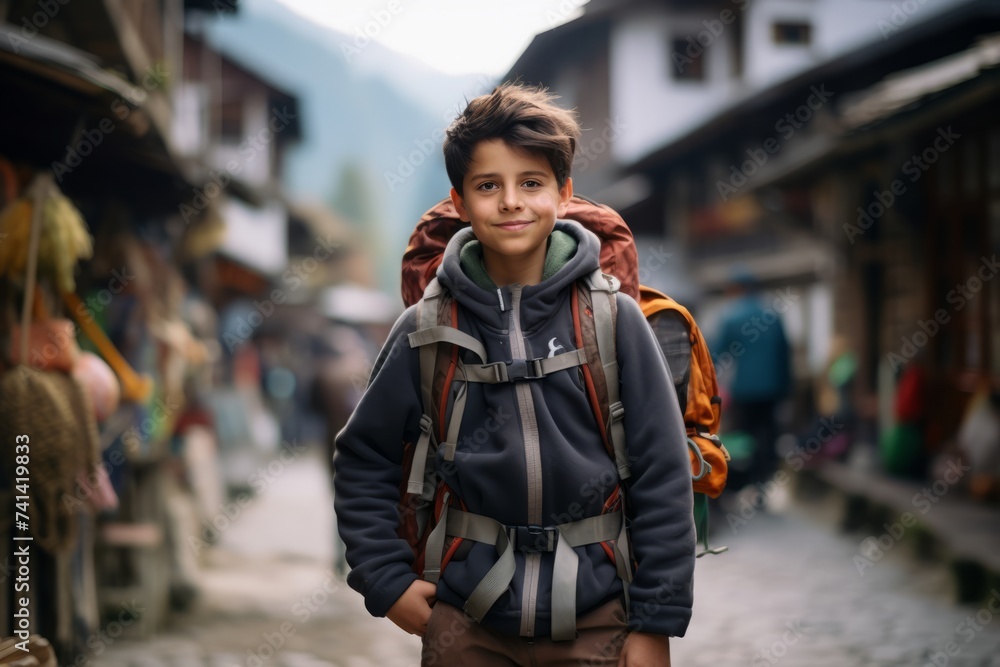 Portrait of a boy with a backpack on the street of the old town