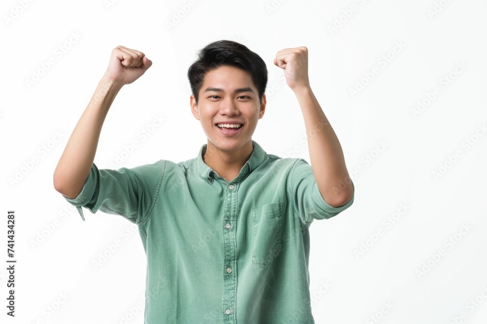 Asian man in green outfit poses happily for collection.