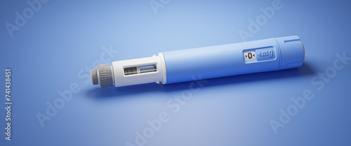 Injector / dosing pen  for subcutaneous injection of antidiabetic medication or anti-obesity medication on blue background. Web banner format photo