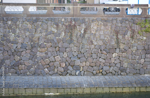 A distant view of a heart-shaped stone on the stone wall at Meganebashi Bridge in Nagasaki. Japan photo