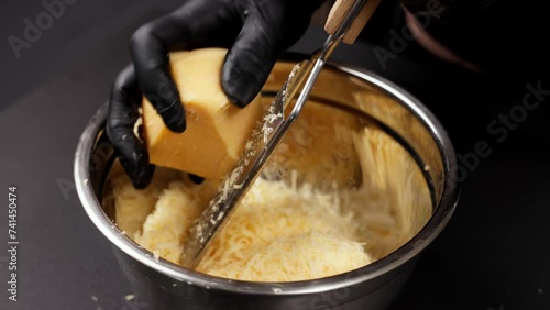 Grating cheese close-up. Food preparation and recipes concept. photo