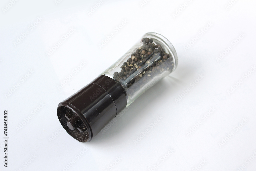 Glass black pepper corns shaker isolated on white background Glass black pepper corns shaker isolated on white background