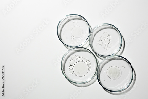 Petri dish with liquid, oil, gel, water, molecules, viruses. On a white background.