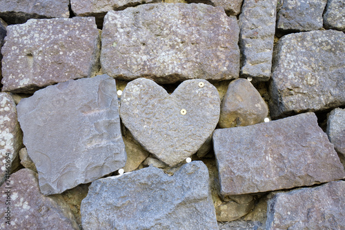 The heart shaped rock on wall stone at Meganebashi Brigde in Nagasaki, Japan photo