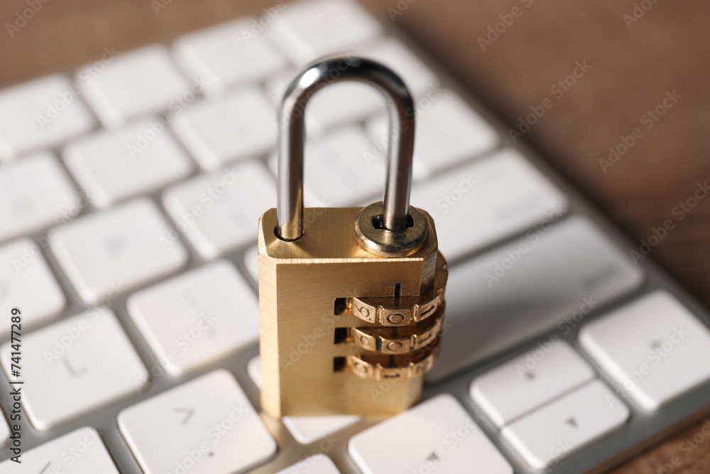 Cyber security. Keyboard with padlock on table, closeup Cyber security. Keyboard with padlock on table, closeup