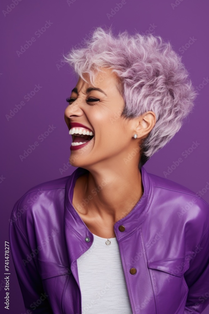 A woman with purple hair laughing and wearing a purple jacket. Suitable for fashion or lifestyle concepts