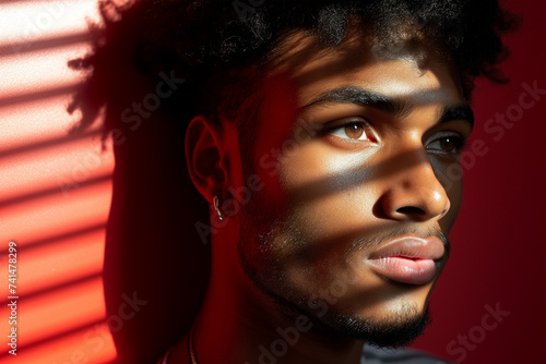 Young african man with striking shadows on his face. Generative AI image