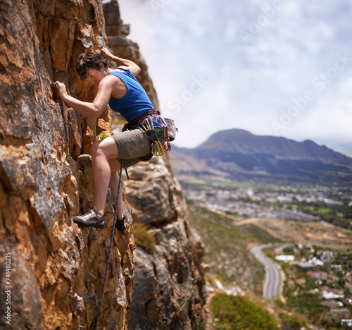 Rock climbing, woman and fitness with adventure, challenge and gear to explore in nature on mountain. Cliff, hiking and sport with athlete and rope for workout, exercise and climber training outdoor