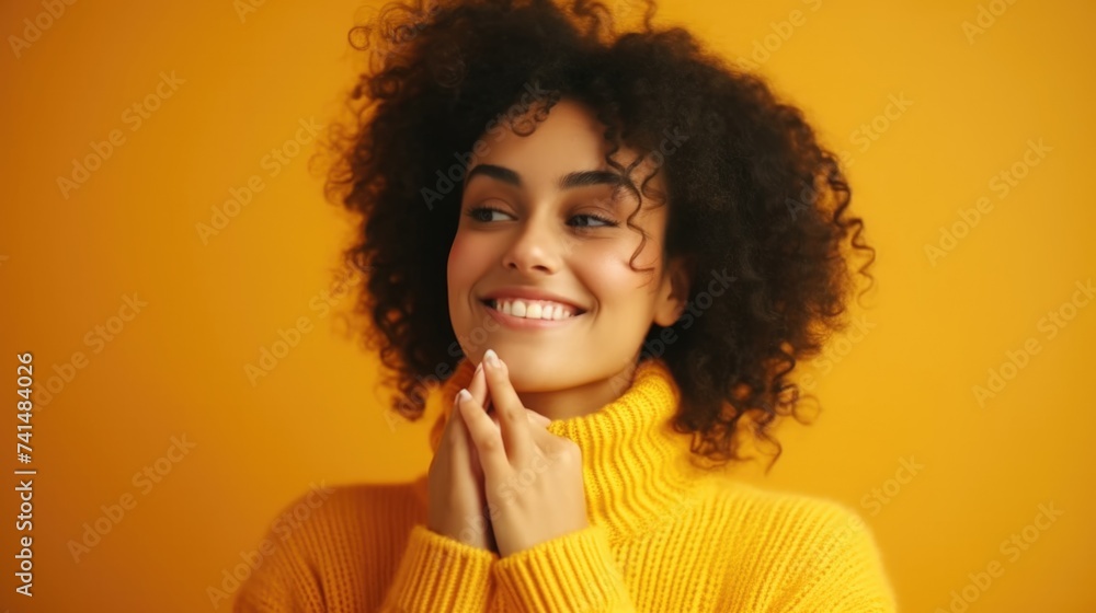 A cheerful woman in a yellow sweater smiling and resting her hand on her chin. Suitable for lifestyle and fashion concepts A cheerful woman in a yellow sweater smiling and resting her hand on her chin. Suitable for lifestyle and fashion concepts