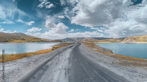 Asphalt road and lake with sky clouds natural scenery in Xinjiang  China.