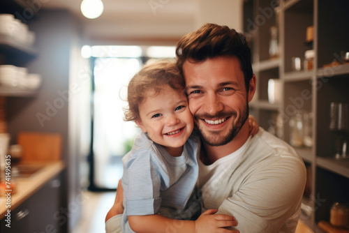 father hugging baby tenderly with cheerful expression on face