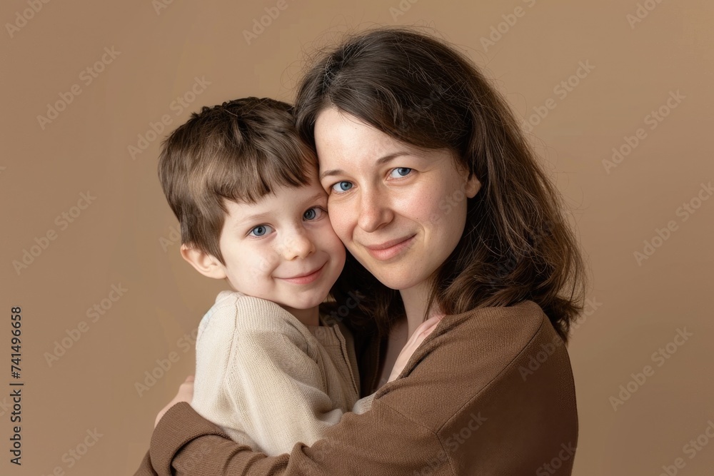 Mother hugging her son, Mother's Day concept, beige background. Mother hugging her son, Mother's Day concept, beige background.