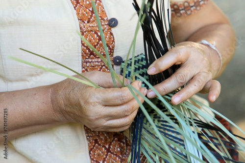 A Thai woman´s hand is weaving an ancestral basket case from bamboo. People are demonstrating weavinga traditional basket made from bamboo. UNESCO Intangible Cultural Heritage of Humanity