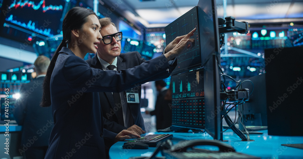 Diverse Female and Male Traders Analyzing Real-Time Financial Data and Reports About the State of the Finance Market. Stock Exchange Professionals Discussing Buy or Sell Options For Different Bonds Diverse Female and Male Traders Analyzing Real-Time Financial Data and Reports About the State of the Finance Market. Stock Exchange Professionals Discussing Buy or Sell Options For Different Bonds