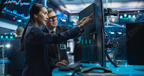 Diverse Female and Male Traders Analyzing Real-Time Financial Data and Reports About the State of the Finance Market. Stock Exchange Professionals Discussing Buy or Sell Options For Different Bonds