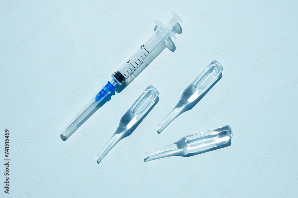 Medicine ampoules. Blue background, hard shadows. Medicine ampoules. Blue background, hard shadows.