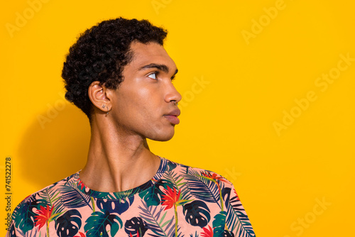 Profile photo of attractive handsome boyfriend gay with piercing and earrings looking mockup barbershop isolated on yellow color background