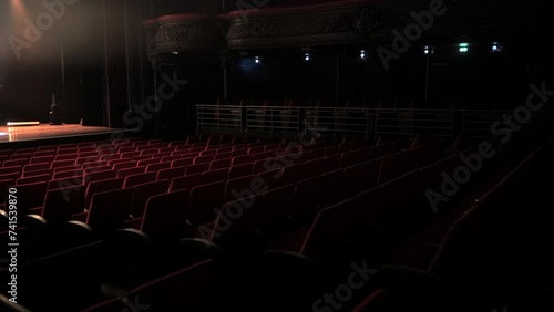 Empty theatre/concert venue with red seats photo