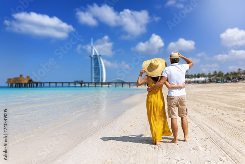 A beautiful tourist couple stands hugging on a beautiful beach in Dubai