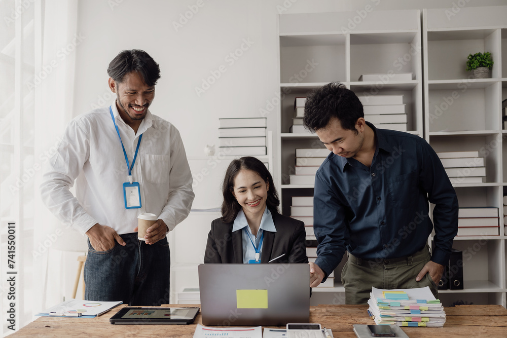 Meeting of young Asian businessmen by laptop, planning and teamwork in meeting to get information, charts and strategies. Managing projects, budgets, and reporting with office staff.