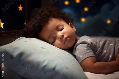 Cute little African American boy sleeping in the bed at night.