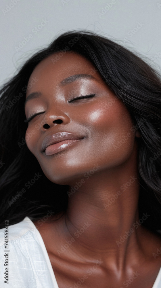 Fototapeta premium Young adult African American woman posing for beauty portrait. Pretty smiling happy Black girl fashion model smiling on background, attractive ethnic girl looking at camera. Close up face .