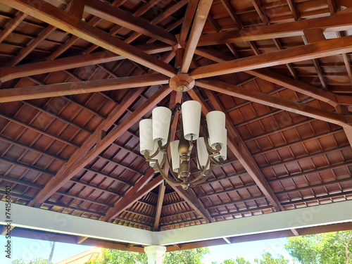 antique hanging lamp on wooden ceiling, Indonesian Javanese style interior roof building.