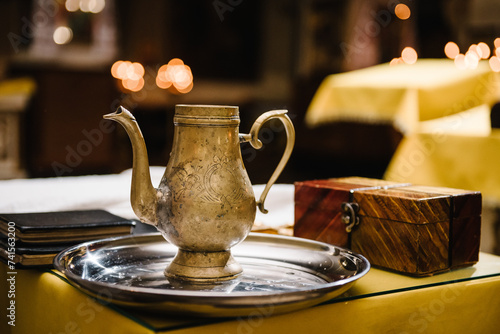 Fotografie A cup or jug with holy water for christening