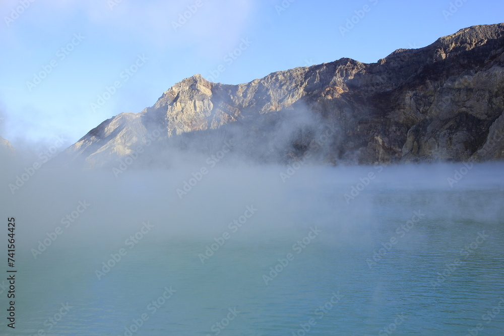 Obraz premium The haze covers surface of Ijen crater lake which is blue and has a high level of acidity due to the sulfur content.
