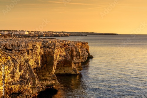 view of the oceanside cliffs of Puos Point on the western coast of Menorca Island photo
