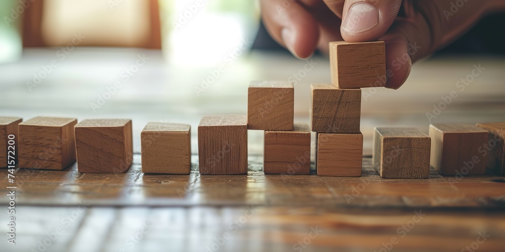 Strategic Blueprint: Hands Strategically Organize Wooden Blocks ...