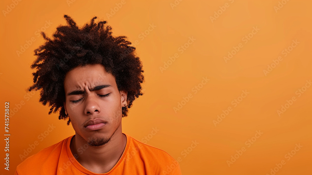 Latino Afro-American Man Expressing Sadness and Grief, Isolated on Solid Background - Copy Space Provided - obrazy, fototapety, plakaty 