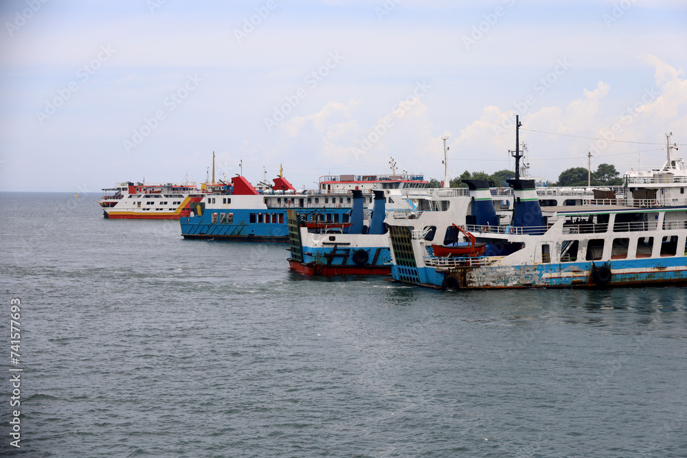 Ferries sail on the sea, ferries in the Bali Strait as a means of transportation between islands in Indonesia. inter-island logistics and economic crossing and shipping modes.