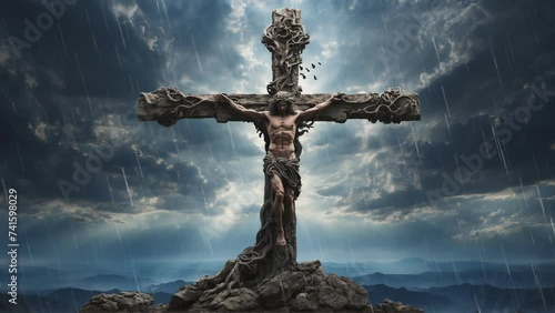 Jesus Christ crucified on the cross on the hill of Calvary with clouds and hills in the background. 4k looping animation photo