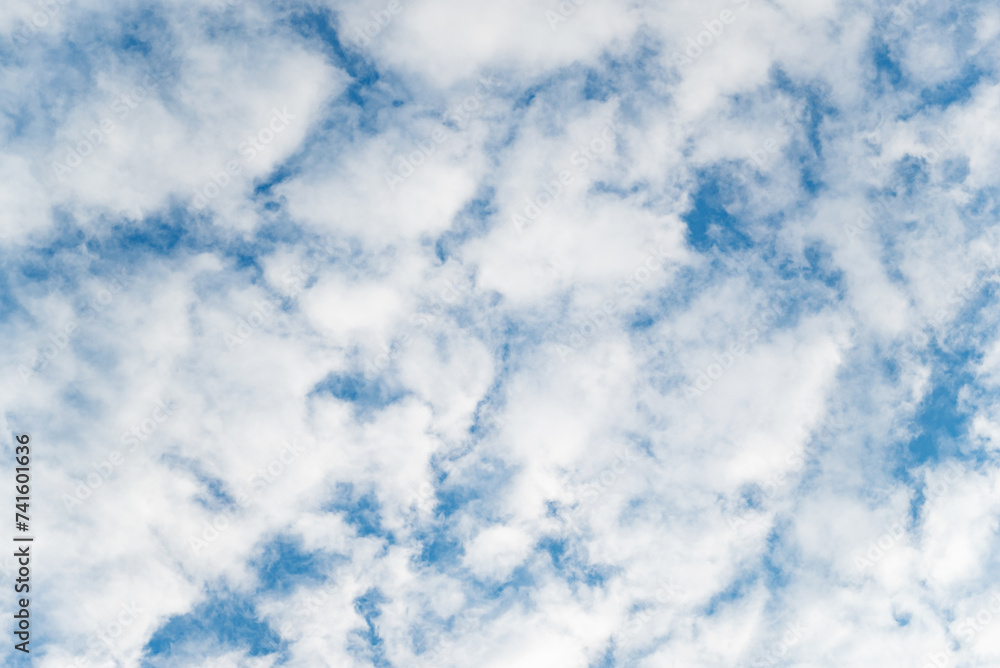 Elegant white clouds and blue sky background. Clouds spreading on the sky in sunny day. Glowing white clouds on the blue sky. Cumulus clouds with deep blue sky. Nature concept background Elegant white clouds and blue sky background. Clouds spreading on the sky in sunny day. Glowing white clouds on the blue sky. Cumulus clouds with deep blue sky. Nature concept background