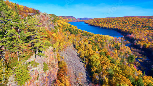 Aerial Autumn Splendor of Forested Landscape with Serene River in Michigan